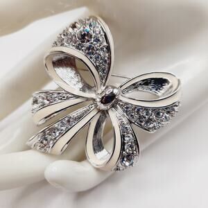 Vintage Nolan Miller Bow Brooch Rhodium Plated Clear Rhinestone White Enamel